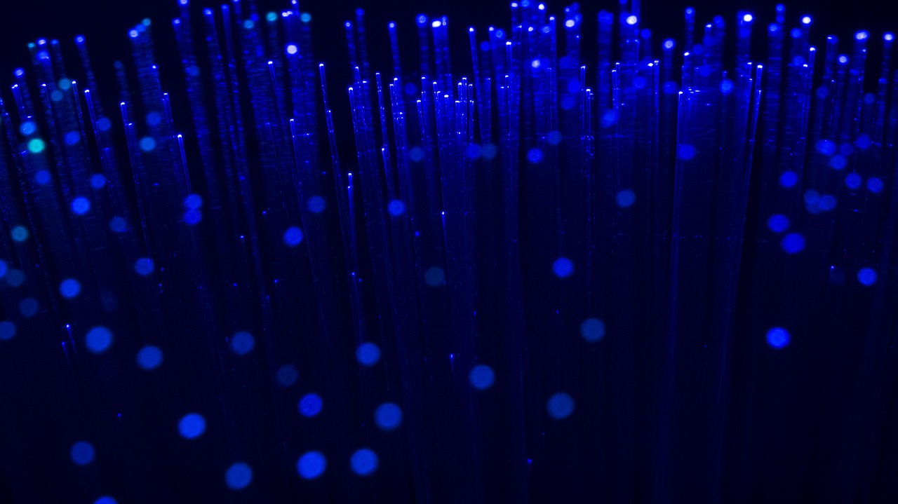 Glowing optical fibres carrying bright coloured light
